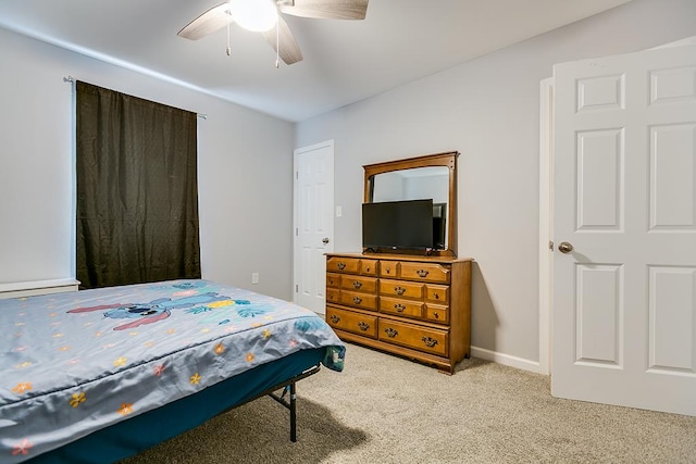 bedroom with ceiling fan, carpet floors, and baseboards