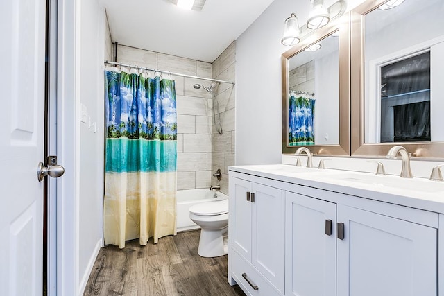 full bath with double vanity, wood finished floors, a sink, and shower / tub combo with curtain