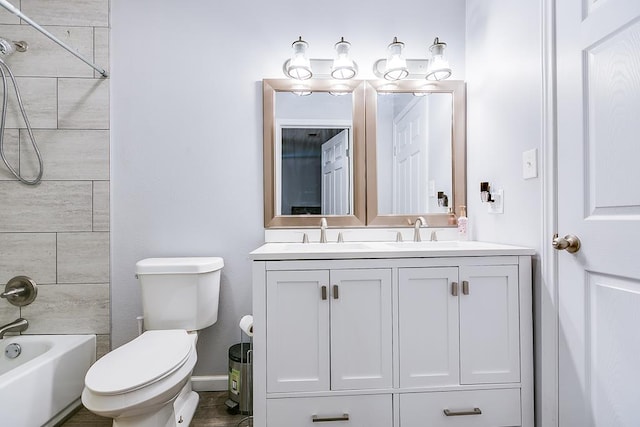 full bath with toilet, double vanity, washtub / shower combination, and a sink