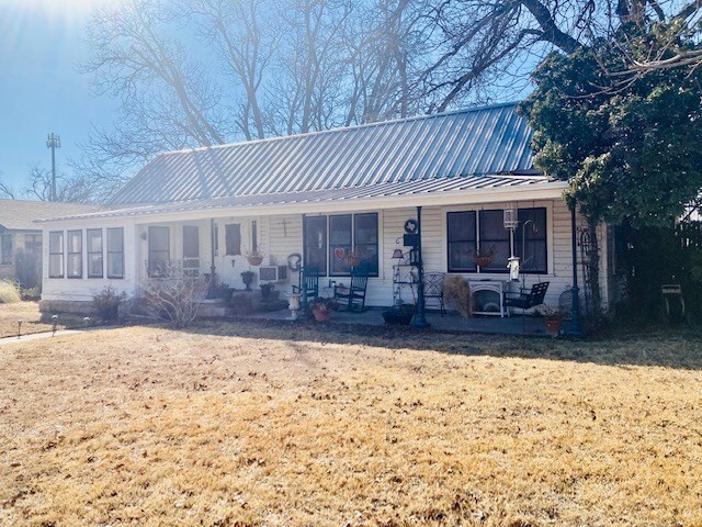 view of front of home with a porch and a front yard