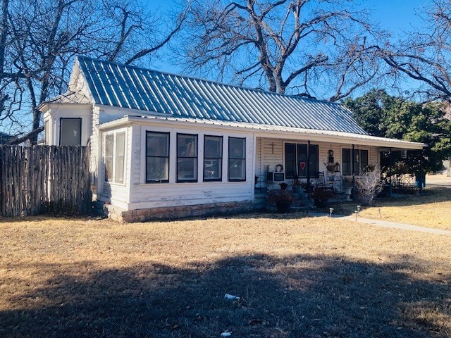 view of front of home with a porch and a front yard