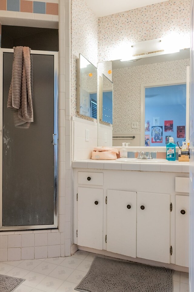 full bath with vanity, tile patterned floors, and a shower stall