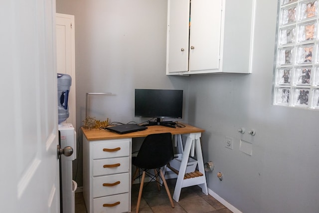 home office with baseboards and tile patterned flooring