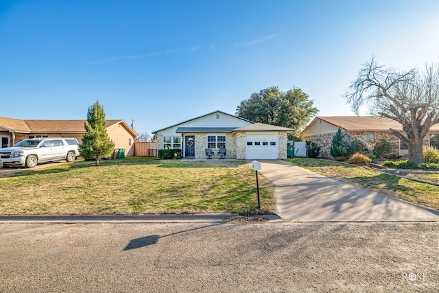 ranch-style home featuring an attached garage, concrete driveway, fence, and a front lawn