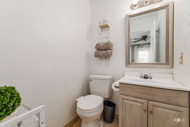bathroom featuring vanity, baseboards, a ceiling fan, and toilet