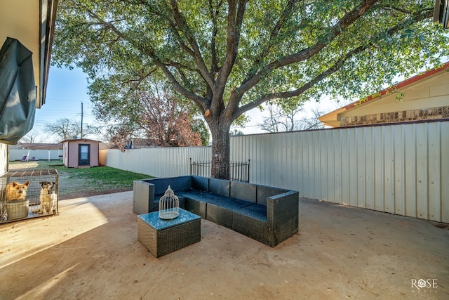 view of patio featuring an outdoor living space, an outbuilding, a fenced backyard, and a shed