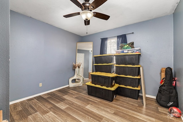 bedroom featuring wood finished floors, ceiling fan, and baseboards
