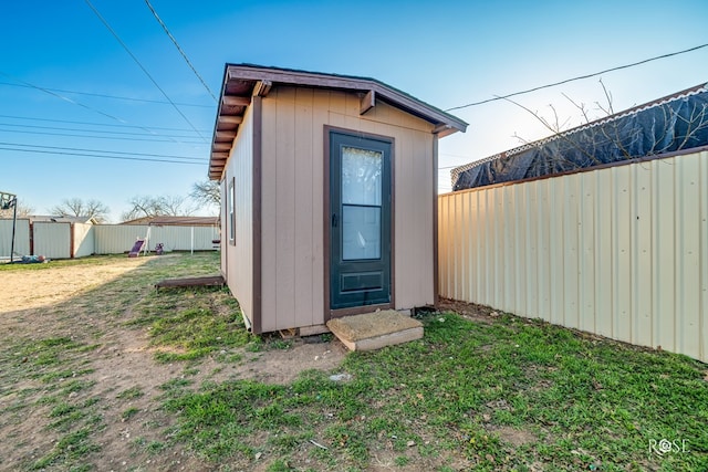 view of shed featuring fence