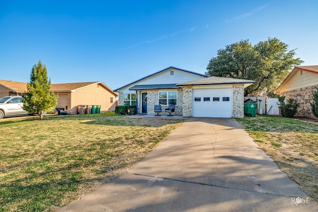 ranch-style house featuring a front yard, an attached garage, fence, brick siding, and driveway
