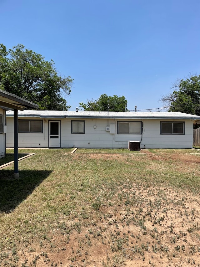 131 Oakwood St, San Angelo, TX 76903 - back of house featuring a lawn and central AC unit