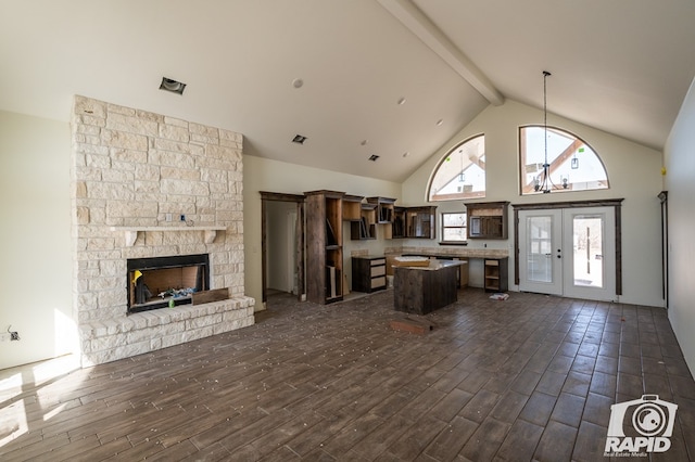 kitchen with dark brown cabinetry, a kitchen island, open floor plan, dark wood-type flooring, and french doors