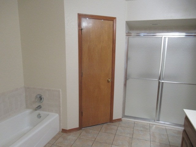 bathroom with tile patterned flooring, vanity, and shower with separate bathtub