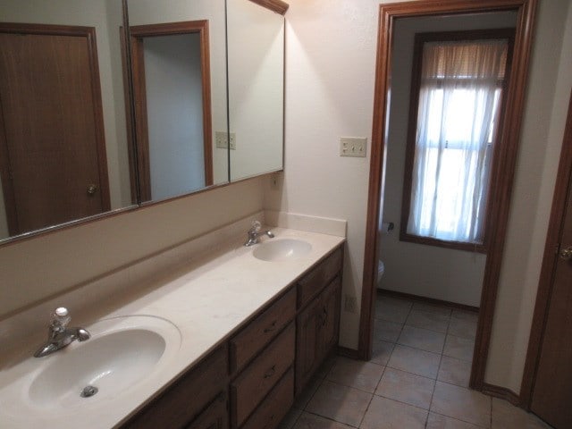 bathroom with vanity, tile patterned floors, and toilet