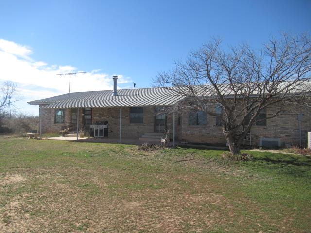 back of house with a yard and a patio