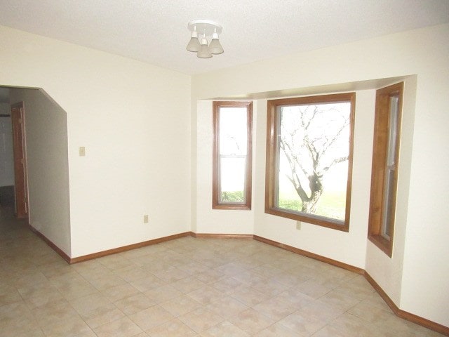 unfurnished room featuring an inviting chandelier