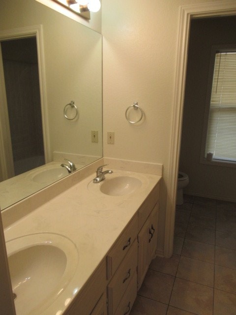 bathroom with vanity, tile patterned floors, and toilet