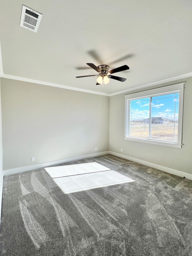 carpeted spare room featuring ornamental molding and ceiling fan