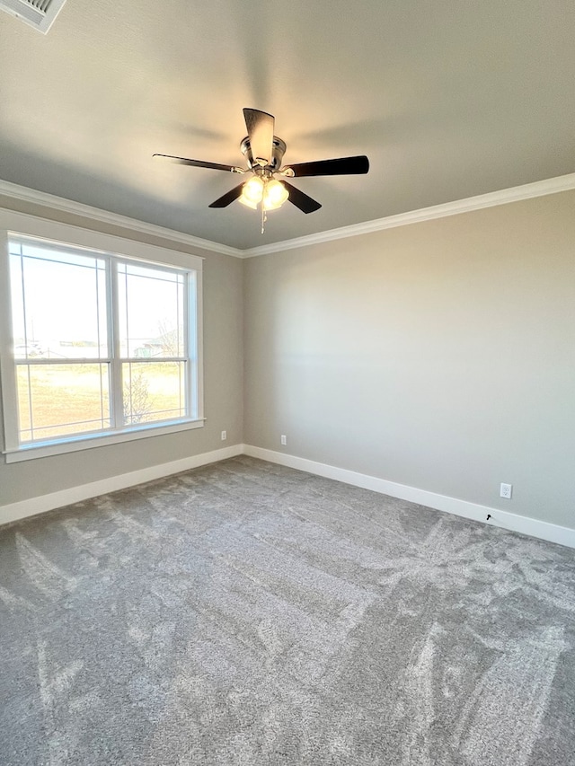 carpeted spare room featuring ornamental molding and ceiling fan