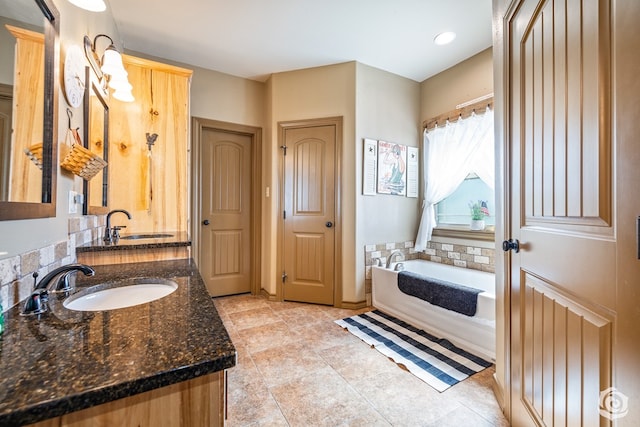 3537 Buck Run, San Angelo, TX 76901 - bathroom with a sink, double vanity, a bath, and tile patterned floors