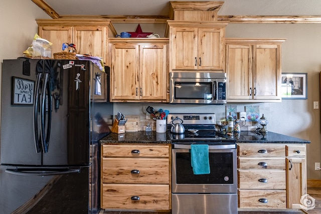 3537 Buck Run, San Angelo, TX 76901 - kitchen with stainless steel appliances, dark stone counters, and light brown cabinetry