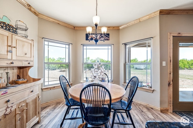 3537 Buck Run, San Angelo, TX 76901 - dining room with baseboards, ornamental molding, a chandelier, and light wood-type flooring
