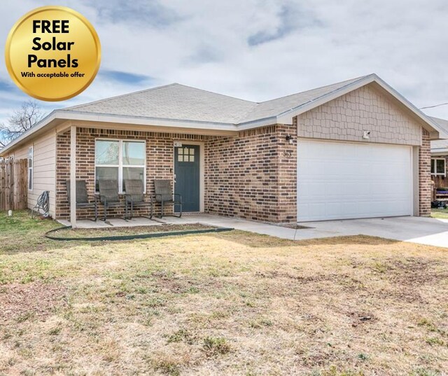 363 E 49th St, San Angelo, TX 76903 - ranch-style house with an attached garage, brick siding, and driveway