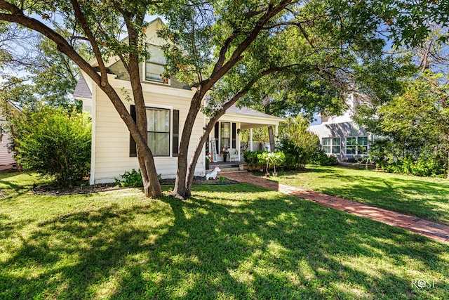 view of front of property with covered porch and a front lawn