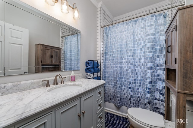 bathroom with crown molding, vanity, and toilet