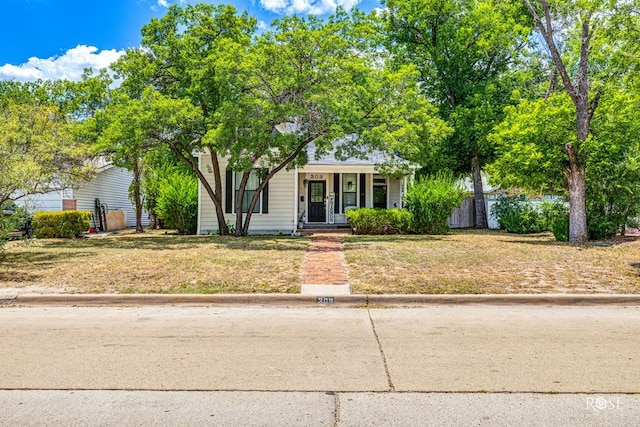 view of front of home with a porch and a front lawn