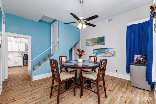 dining space featuring light hardwood / wood-style floors and ceiling fan