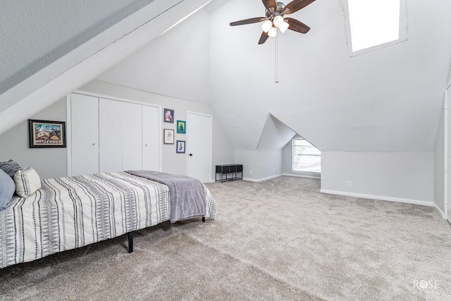 carpeted bedroom featuring ceiling fan and vaulted ceiling