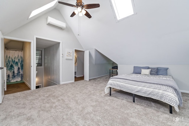 carpeted bedroom featuring lofted ceiling with skylight, a wall mounted air conditioner, and ceiling fan