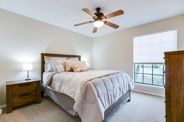 4413 Pinon Ridge Dr, San Angelo, TX 76904 - bedroom with light carpet, ceiling fan, and baseboards
