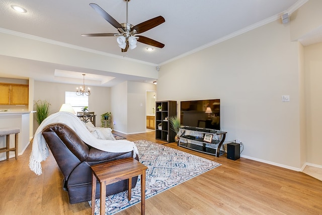 4413 Pinon Ridge Dr, San Angelo, TX 76904 - living room with crown molding, light wood-style flooring, baseboards, a ceiling fan, and a chandelier