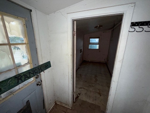 hall featuring lofted ceiling