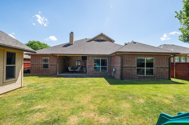 3918 Caroline Ln, San Angelo, TX 76904 - rear view of property featuring brick siding, a chimney, a patio, and a playground