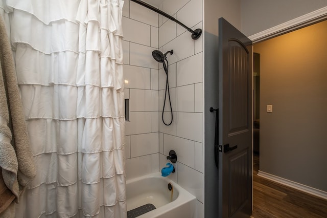 3918 Caroline Ln, San Angelo, TX 76904 - bathroom with wood finished floors, shower / bath combination with curtain, and baseboards
