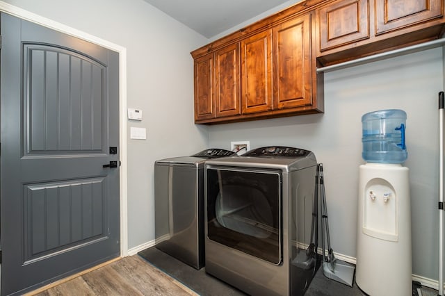 3918 Caroline Ln, San Angelo, TX 76904 - clothes washing area featuring washer and clothes dryer, cabinet space, wood finished floors, and baseboards