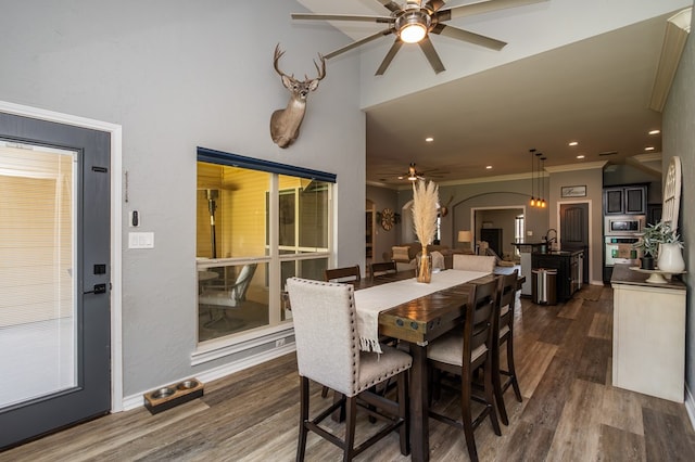 3918 Caroline Ln, San Angelo, TX 76904 - dining space featuring ceiling fan, dark wood-style floors, arched walkways, crown molding, and recessed lighting