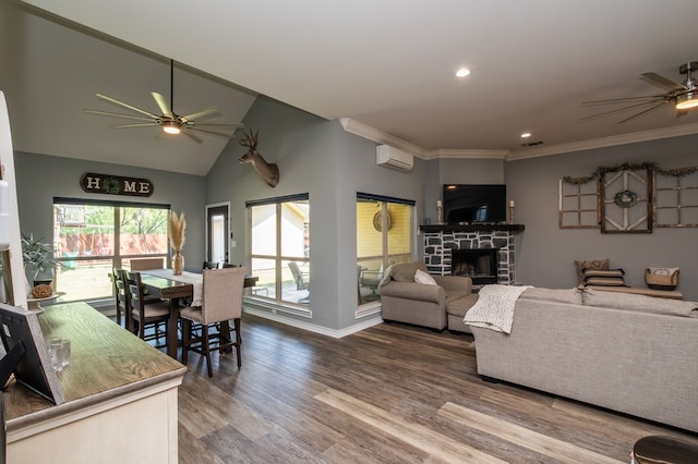 3918 Caroline Ln, San Angelo, TX 76904 - living room with ceiling fan, a wall unit AC, a stone fireplace, wood finished floors, and recessed lighting
