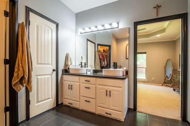 3918 Caroline Ln, San Angelo, TX 76904 - bathroom featuring ornamental molding, tile patterned floors, double vanity, a tray ceiling, and baseboards