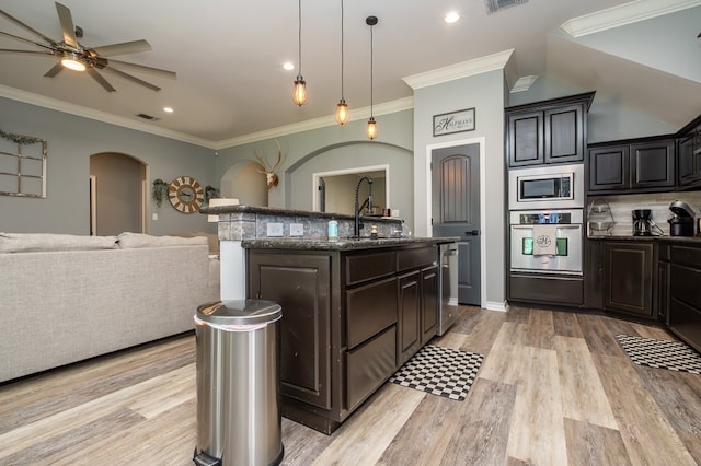 3918 Caroline Ln, San Angelo, TX 76904 - kitchen featuring appliances with stainless steel finishes, arched walkways, a sink, open floor plan, and ceiling fan