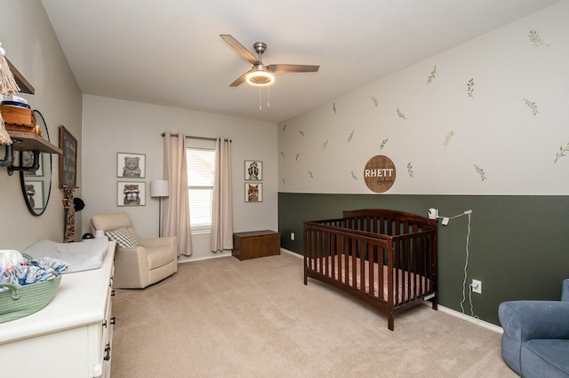 3918 Caroline Ln, San Angelo, TX 76904 - bedroom featuring light colored carpet, a nursery area, ceiling fan, and baseboards