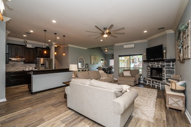3918 Caroline Ln, San Angelo, TX 76904 - living room with a ceiling fan, crown molding, recessed lighting, wood finished floors, and a fireplace