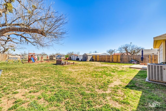 view of yard featuring a playground and a storage shed