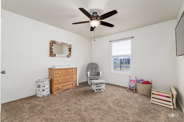 sitting room featuring ceiling fan and carpet floors