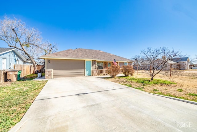 single story home with a garage, a front lawn, and a porch