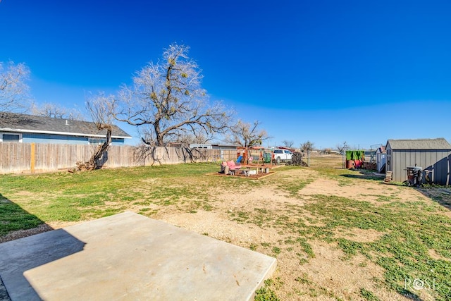 view of yard with a playground, a patio, and a storage shed