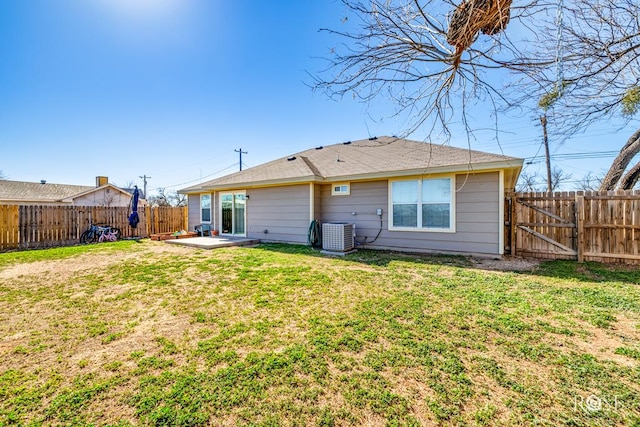 back of house with central AC, a patio area, and a lawn