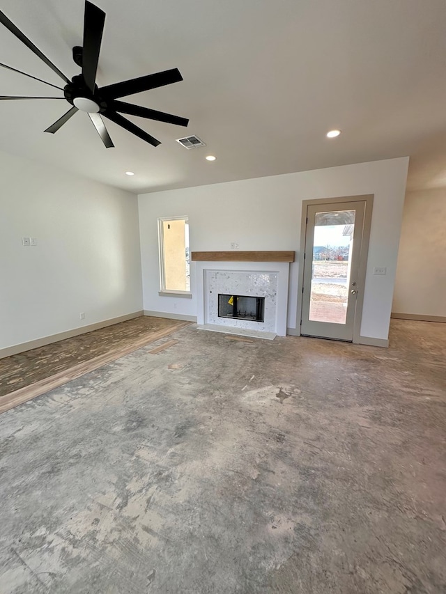 unfurnished living room with a ceiling fan, baseboards, visible vents, recessed lighting, and a high end fireplace